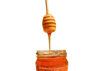 Wall Mural - polyflora bee honey flowing into a jar from a wooden spoon. The concept of beekeeping