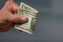 Close-up Of A Man's Hand Holding A Dollar Bill / Greenback