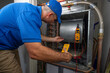 © spatesphoto - Hvac Technician Checking for Refrigerant Leaks on a Heat Pump