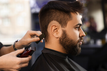 Canvas Print - Professional hairdresser working with client in barbershop