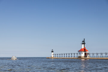 Boat in the channel and St. Joseph North Pier Inner Lighthouse and St. Joseph North Pierhead Outer Lighthouse, Michigan 