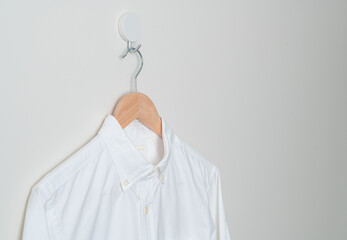 Sticker - hanging shirt with wood hanger on wall