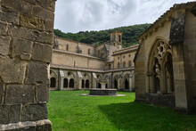 Monastery Of Santa María La Real De Iranzu, Interior Courtyard With A Central Fountain Surrounded By Arches Carved In Stone, Navarra, Spain.