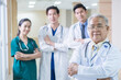 © Boonkung - Portrait Group of Asian doctor and nurse crossing arm with smiling. Professional medical team standing in hospital office ward and giving encouragement to patient people after work in recovery room.