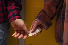 Unrecognizable High School Students Dealing Drugs In Shool Corridor.