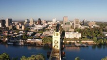 Wide Panning Aerial Shot Of Tower Bridge On The Sacramento River With Downtown Sacramento In The Background. 4K