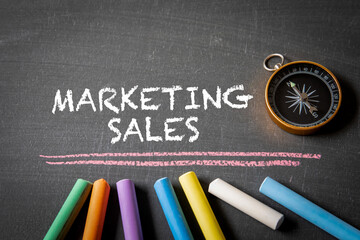Wall Mural - marketing sales. compass and colored pieces of chalk on a blackboard