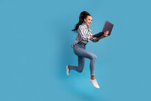 Photo Of Pretty Charming Woman Using Device Jumping Running Isolated Blue Color Background