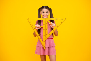 Sticker - School girl holding measure for geometry lesson, isolated on yellow background. Measuring equipment. Student study math. Happy teenager, positive and smiling emotions of teen schoolgirl.