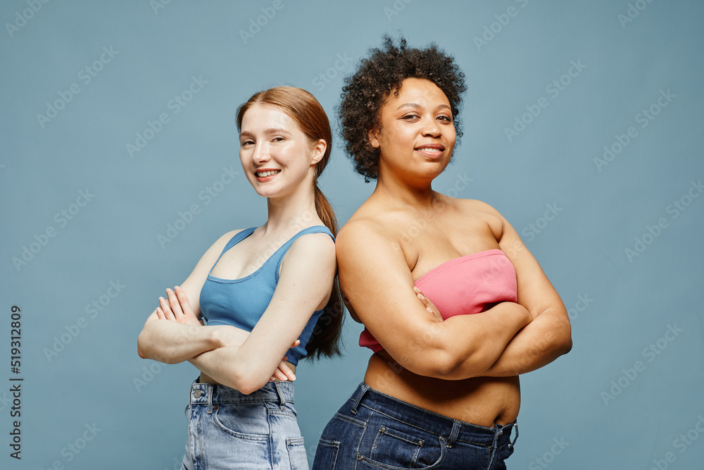 Candid waist up portrait of two confident young women standing against ...