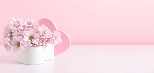 Pink flowers in heart-shaped pink gift box on pink background. Valentine's Day, Women's Day, Mother's Day, Birthday, Wedding