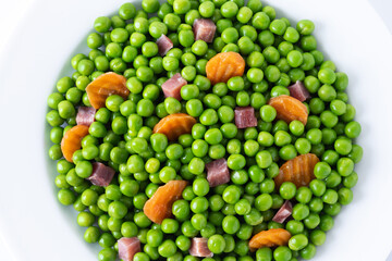 Wall Mural - Green peas with serrano ham and carrot isolated on white background	