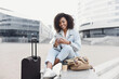 © kite_rin - Beautiful woman tourist with suitcase luggage using smart phone outdoor. Smiling student girl going on travel. Business travel, student lifestyle, connection, tourism concept