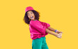 © Studio Romantic - Cheerful funny stylish african american teen girl having fun on vivid yellow background. Happy energetic kid girl in trendy bright colored clothes having fun and fooling around laughing out loud.