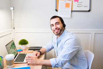 Handsome man smiling while doing telecommute work