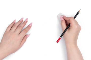 Sticker - Female hands uses an eraser and black pencil on a white background. File contains a path to isolation.