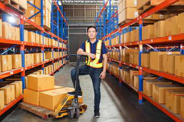 Happy Asian senior supervisor working - inspecting an items in the warehouse.