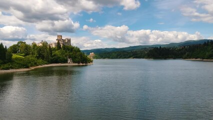 Wall Mural - Niedzica Castle Also Known as Dunajec Castle by Lake Czorsztynin the Pieniny Mountains, Poland. And Tourist Ferrys in the Lake. Summer Day With Fast Moving Clouds.  