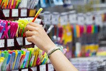Partial View Of Woman In Beaded Bracelets Near Colorful Pencils In Stationery Shop.