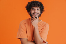 Portrait Of Young Indian Handsome Curly Smiling Man Touching Chin