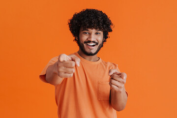 Portrait of young indian handsome curly smiling man