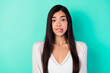 © deagreez - Photo of worried young indonesian person biting lips look camera isolated on bright teal color background