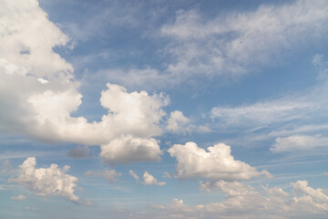Wall Mural - beautiful well balanced sky replacement background with layers of fluffy white cumulus clouds on a b