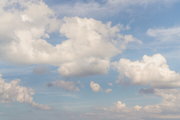 Wall Mural - beautiful well balanced sky replacement background with layers of fluffy white cumulus clouds on a b
