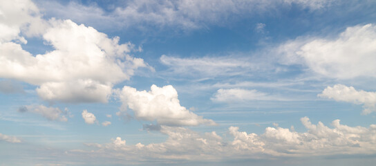 Wall Mural - beautiful panorama or wide angle sky replacement background with layers of fluffy white cumulus clou