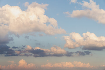 Wall Mural - beautiful well balanced sky replacement sunset background with layers of fluffy white cumulus clouds