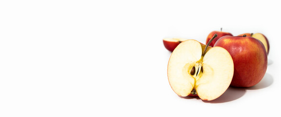 Wall Mural - Whole and cut red fresh apples on white background, side view. Banner