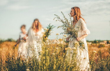 Wall Mural - Women collects beautiful spring flowers in a summer day.