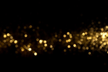 Wall Mural - golden blurred bokeh lights on black background. glitter sparkle stars for celebrate. overlay for yo