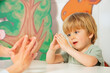 Little boy in development finger game class with therapist