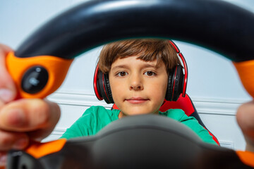 Wall Mural - Through the steering wheel view of gamer boy play race game