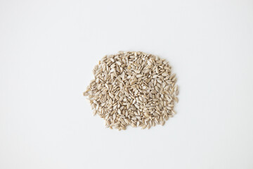 Wall Mural - Shelled sunflower seeds over white background