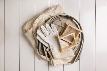 Wall Mural - Honeycomb frames and beekeeping tools on white wooden table, flat lay