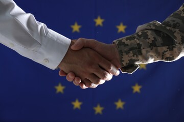 Wall Mural - Soldier and businessman shaking hands against flag of European Union, closeup