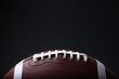 © New Africa - American football ball on black background, closeup. Space for text