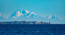 Lighthouse On Headland In Salish Sea With Mountain Backdrop, Vancouver Island, Vancouver, British Columbia, Canada