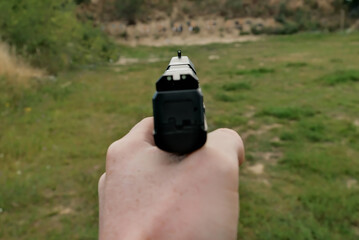 the hand is holding a firearm. pistol . training at the shooting range