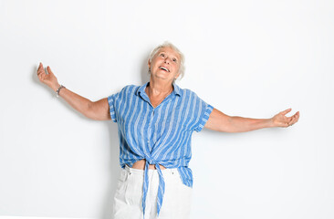 Wall Mural - smiling retired senior woman looking at camera isolated on white background