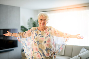 Wall Mural - Active beautiful senior woman in the living room.