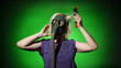 © Sergey - blonde woman in a gas mask with a comb in her hands on a dark background