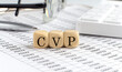 © Iryna - wooden cubes with the word CVP Cost Volume Profit on a financial background with chart, calculator, pen and glasses, business concept.