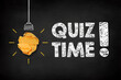 Quiz time concept. Light bulb creative idea with quiz time writing on chalkboard