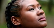 African woman in 20s face looking up to sky. Black ethnicity girl with HOPE