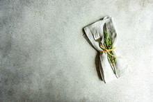 Overhead View Of A Minimalistic Place Setting With Fresh Rosemary