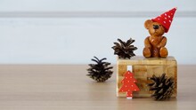 Christmas Composition With A Ceramic Teddy Bear A Red Cap In White Polka Dots, A Red White Polka Dot Christmas Tree And Three Pine Cones