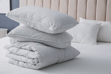 Soft Folded Blanket And Pillows On Bed Indoors, Closeup
